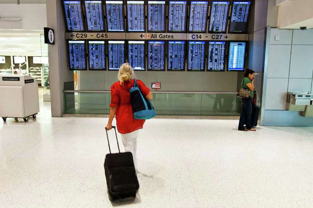 A passenger checks the time tables in Terminal C at George Bush Intercontinental Airport on Thursday, June 16, 2011 in Houston. The airport installed Bluetooth tracking devices by the flight information display to track the movement of people from the security checkpoint to further down the concourse in order to better understand traveler movement and habits. ( Patrick T. Fallon / Houston Chronicle )