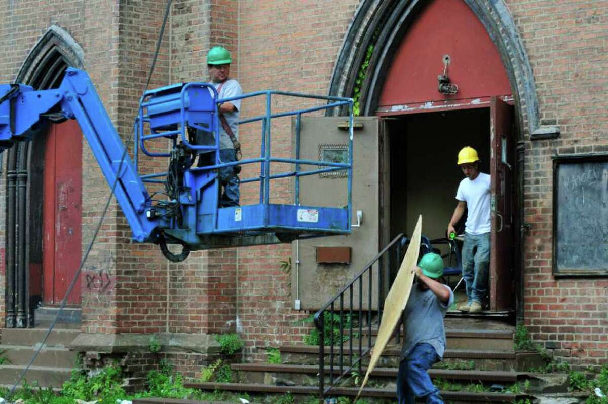 A crew from DiTonno and Sons work at Trinity Church during the salvaging of historic pieces and demolition in Albany, NY Wednesday July 13,2011.( Michael P. Farrell/Times Union )
