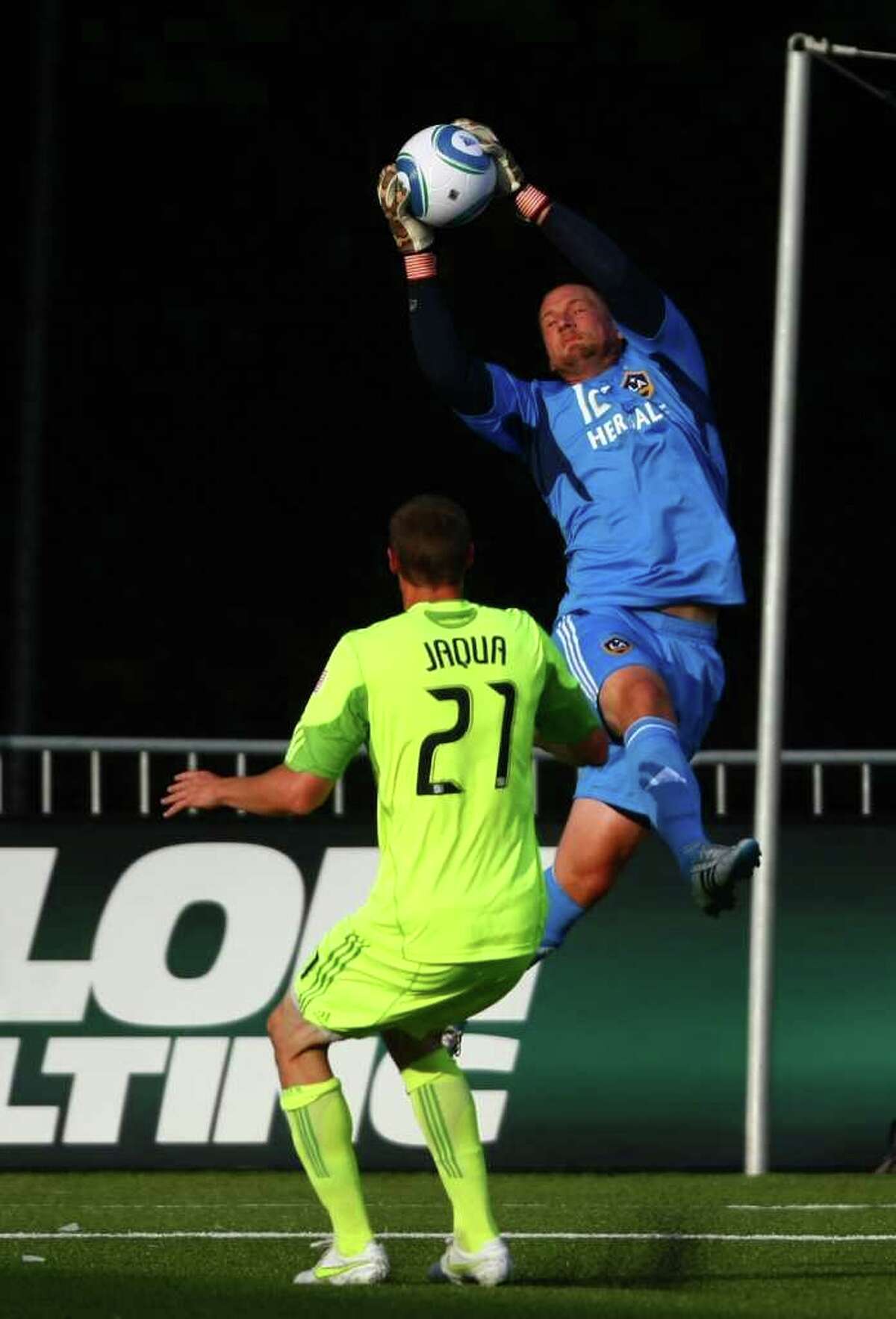 LA Galaxy goalie Josh Saunders stops a goal attempt by Seattle Sounders player Nate Jaqua during the first half of a U.S. Open Cup quarterfinal match at Starfire Sports Complex in Tukwila on Wednesday, July 13, 2011. The Sounders defeated the Galaxy 3-1.