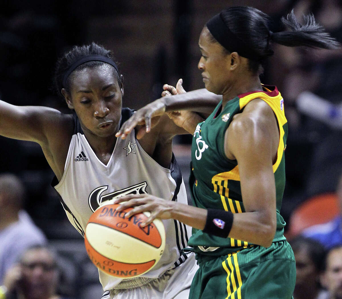 San Antonio's Sophia Young takes a shot at a steal against Swin Cash as the San Antonio Silver Stars play the Seattle Storm at the AT&T Center on July 14, 2011. Tom Reel/Staff