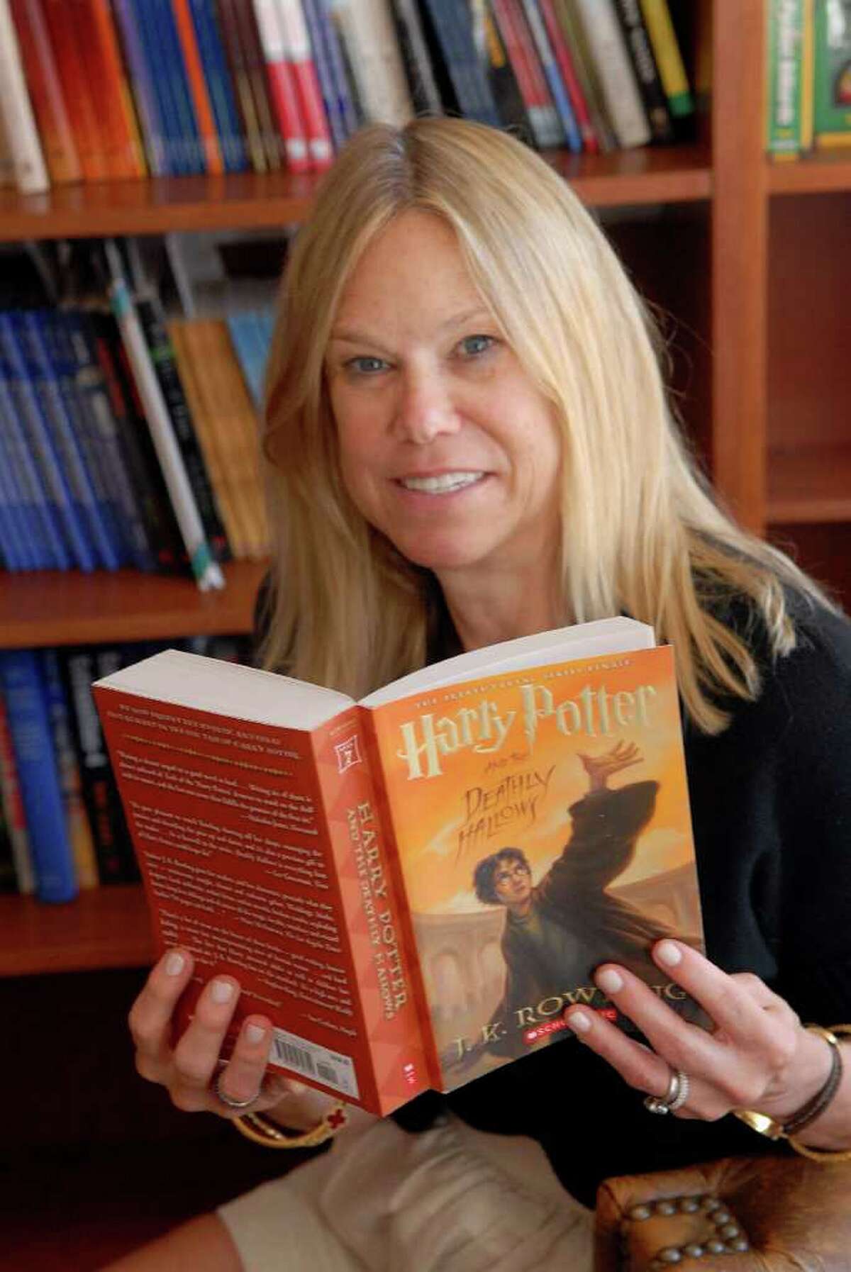 Marion Boucher Holmes of " Just Books" in Old Greenwich, Conn. poses in the store with the last book in the Harry Potter series on July 15, 2011.