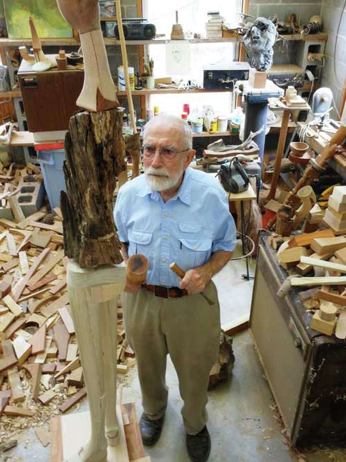 Wood sculptor Phil Evett works on a new piece in his Blanco studio.
