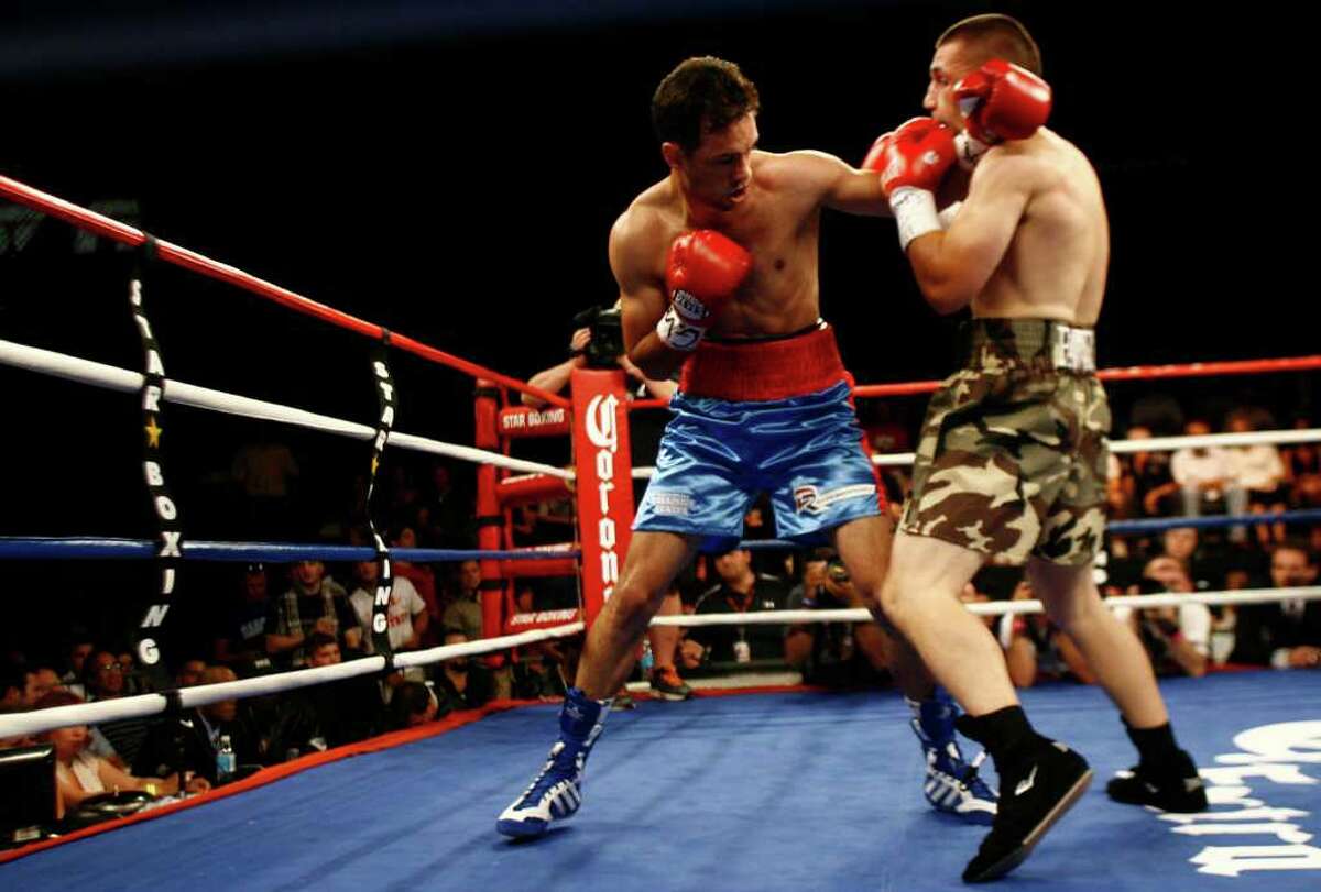 Delvin Rodriguez, of Danbury, in blue/red trunks, fights Pawel Wolak, of New Jersey, in camouflage trunks,during their Junior Middleweight Championship at the Roseland Ballroom in New York City on Friday, July 15, 2011.