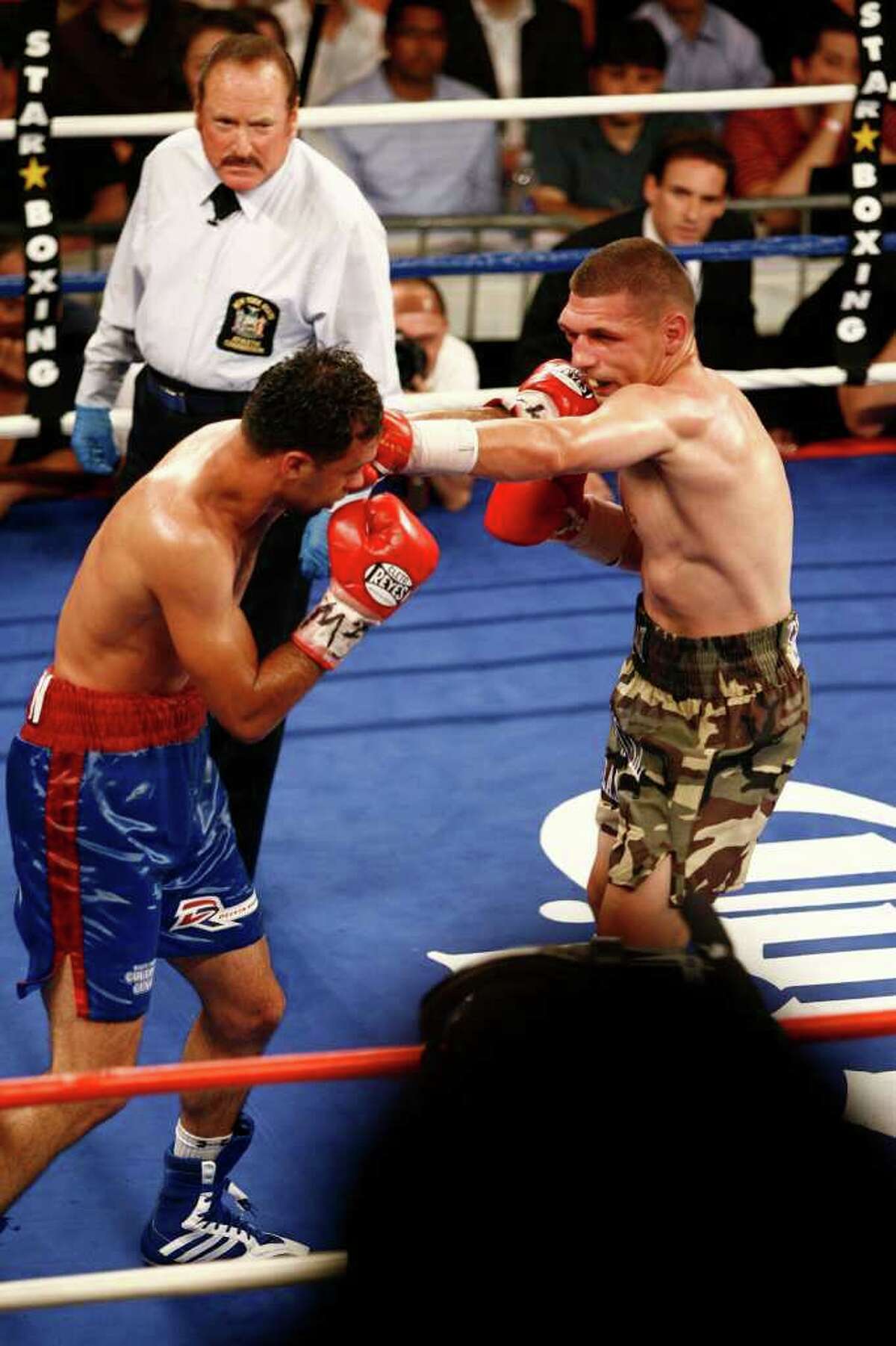 Delvin Rodriguez, of Danbury, in blue/red trunks, fights Pawel Wolak, of New Jersey, in camouflage trunks,during their Junior Middleweight Championship at the Roseland Ballroom in New York City on Friday, July 15, 2011.