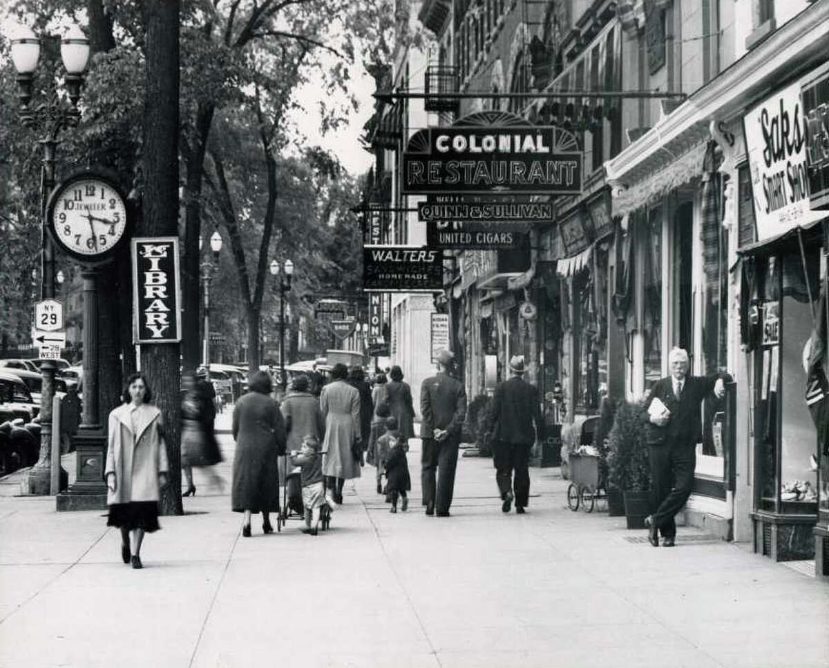 Broadway, between Spring and Phila Streets on May 26, 1938. Standing to the right is Thomas F. MacGovern. (Courtesy of Saratoga Springs Historical Museum, George S. Bolster collection)