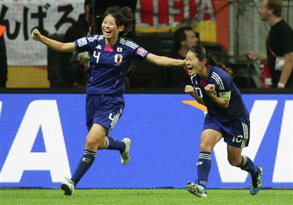 Japan's Homare Sawa, right, celebrates with Japan's Saki Kumagai scoring her side's second goal during the final match between Japan and the United States at the Women�s Soccer World Cup in Frankfurt, Germany, Sunday, July 17, 2011. (AP Photo/Michael Probst)