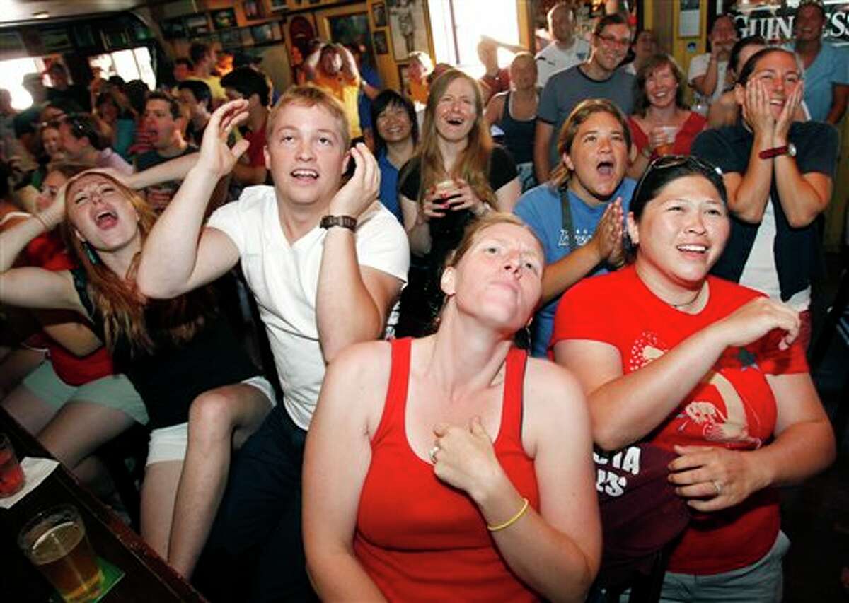 Fans react at Tommy Doyle's pub in Cambridge, Mass., as they watch television coverage of the first half of the Women's World Cup soccer final between the United States and Japan being played in Germany, Sunday, July 17, 2011. (AP Photo/Michael Dwyer)