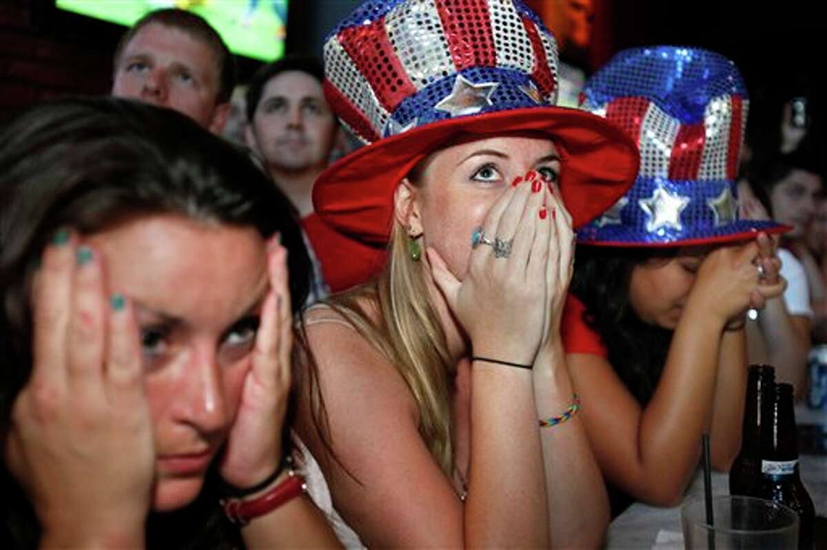 Jessica Doyle, center, and other fans react Sunday, July 17, 2011, in Washington as the U.S. loses to Japan during the Women's World Cup soccer final in Germany. (AP Photo/Jacquelyn Martin)