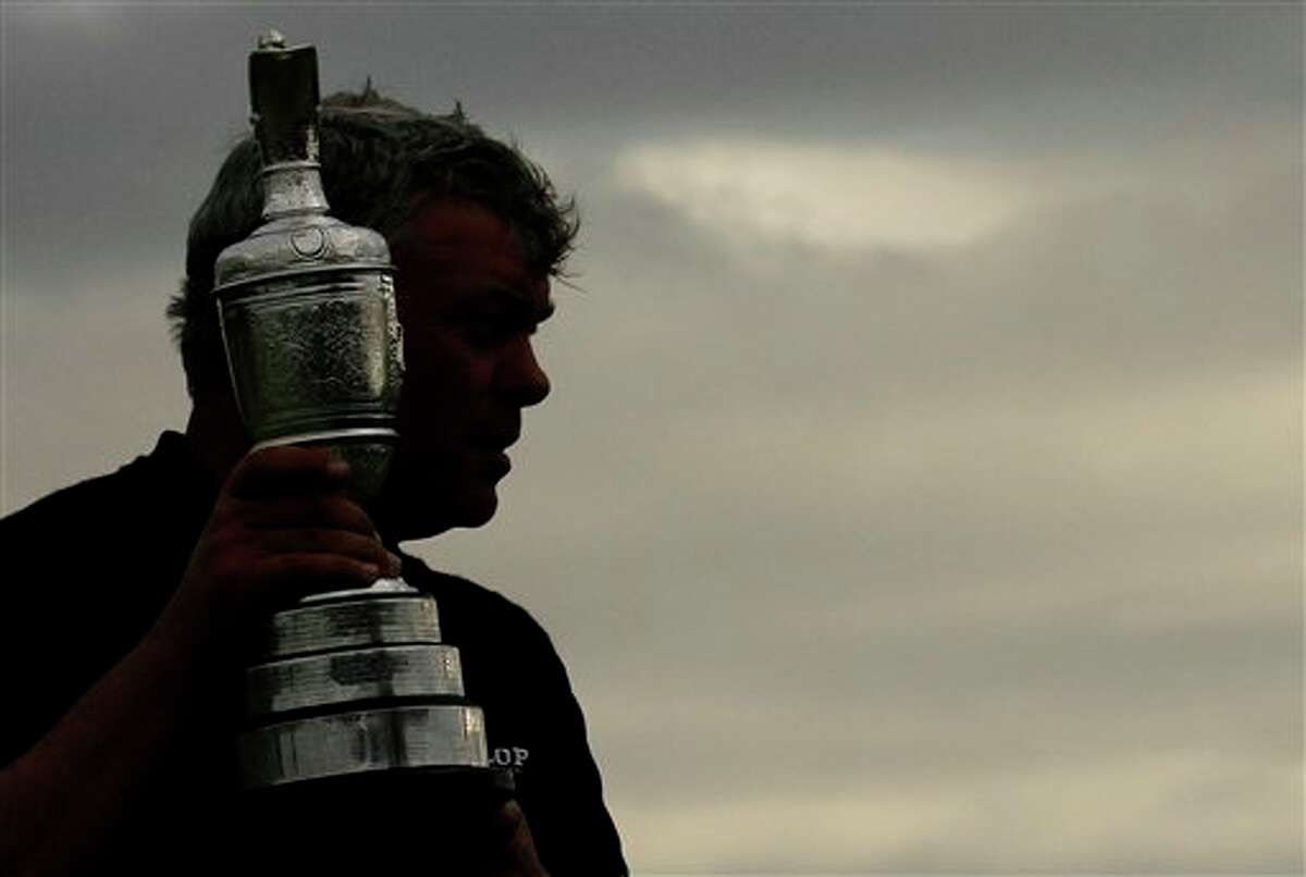 Northern Ireland's Darren Clarke holds the Claret Jug trophy as he celebrates winning the British Open Golf Championship at Royal St George's golf course Sandwich, England, Sunday, July 17, 2011. (AP Photo/Peter Morrison)