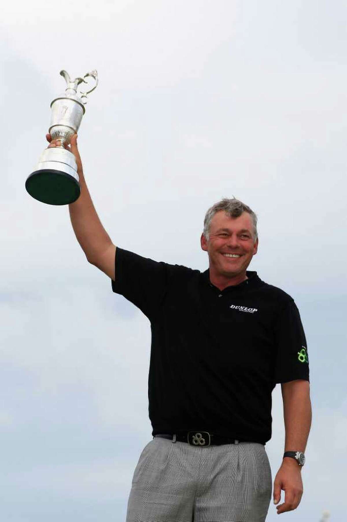 SANDWICH, ENGLAND - JULY 17: Darren Clarke of Northern Ireland holds the Claret Jug aloft following his victory at the end of the final round of The 140th Open Championship at Royal St George's on July 17, 2011 in Sandwich, England. (Photo by Streeter Lecka/Getty Images)