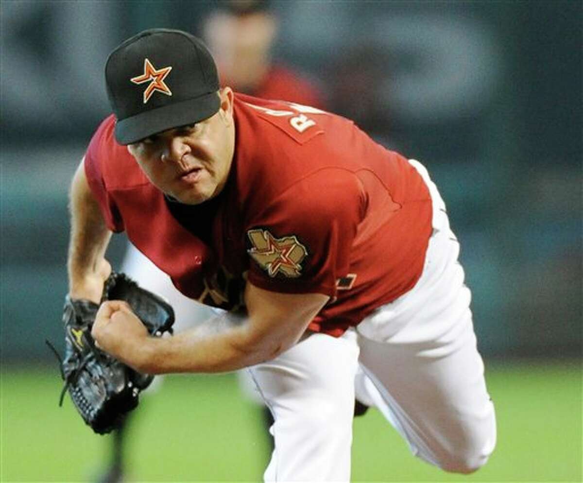 Houston Astros' Wandy Rodriguez follows through on a pitch in the second inning against the Pittsburgh Pirates in a baseball game Sunday, July 17, 2011, in Houston. (AP Photo/Pat Sullivan)