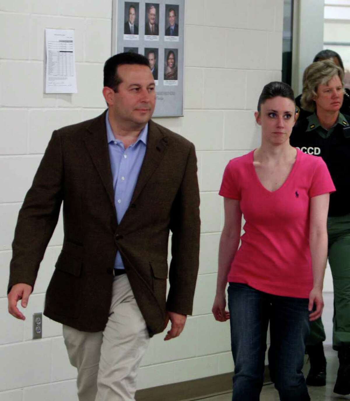 Casey Anthony, front right, walks out of the Orange County Jail with her attorney Jose Baez, left, during her release in Orlando, Fla., early Sunday, July 17, 2011. Anthony was acquitted last week of murder in the death of her daughter, Caylee.
