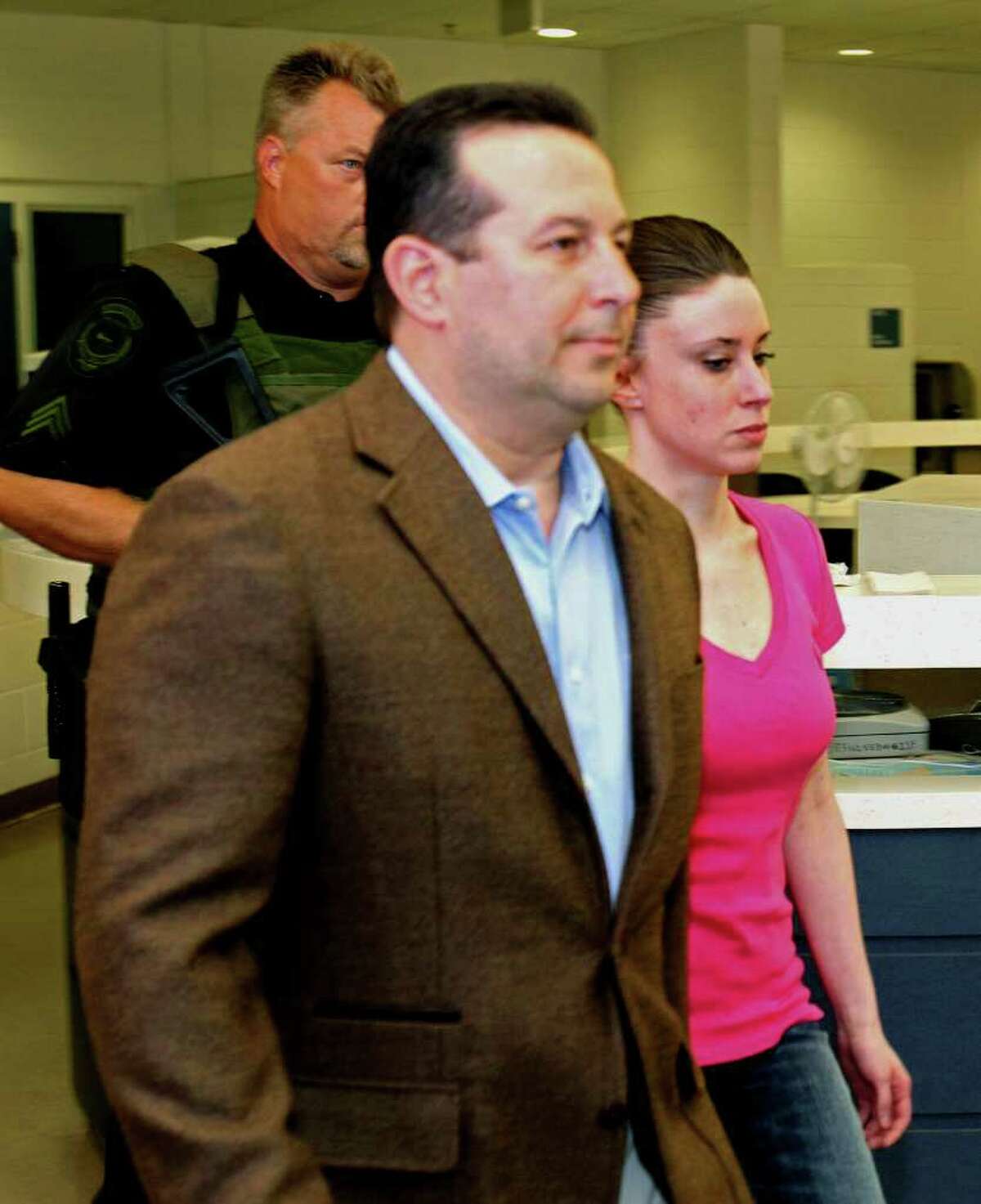 Casey Anthony, front right, walks out of the Orange County Jail with her attorney Jose Baez, left, during her release in Orlando, Fla., Sunday, July 17, 2011. Anthony was acquitted last week of murder in the death of her daughter, Caylee.