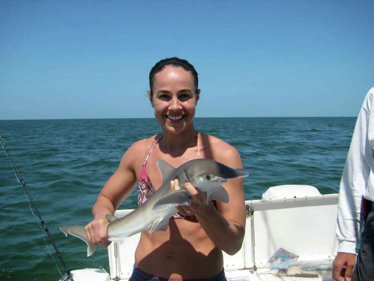 3. Hammon is an avid shark angler. Here she is seen with a baby bonnethead shark she caught while fishing in Florida during the 2009 offseason.