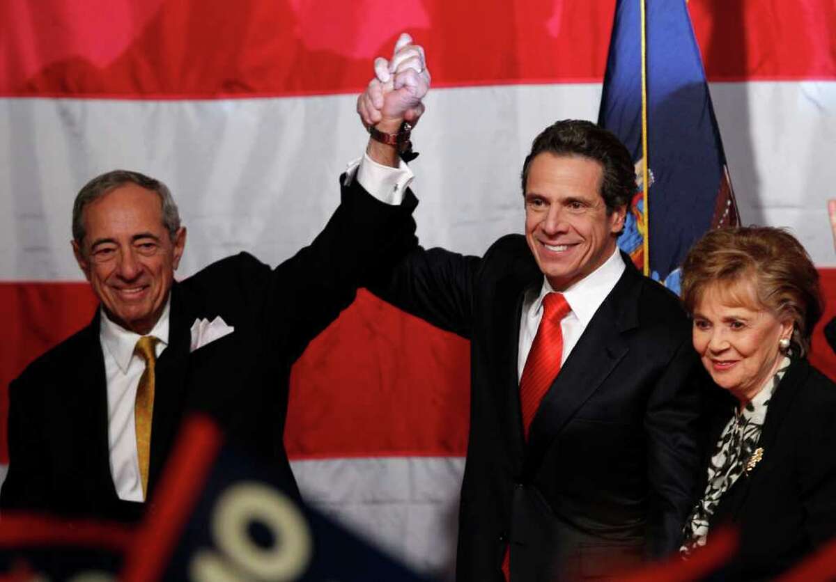 New York Governor-elect Andrew Cuomo, center, gestures with his father, former New York Gov. Mario Cuomo, left, and his mother Matilda, right, before giving his victory speech Tuesday, Nov. 2, 2010, in New York. (AP Photo/Kathy Willens)