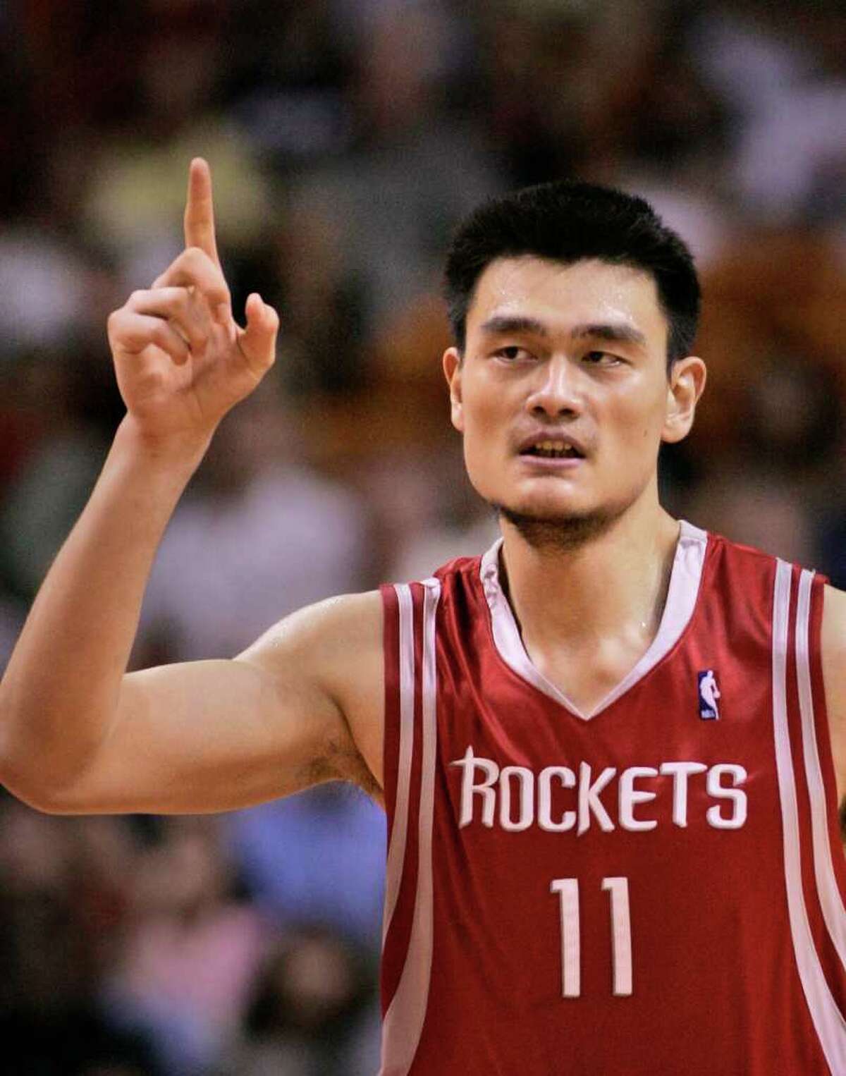 FILE - In this Nov. 12, 2006, file photo, Houston Rockets center Yao Ming, of China, celebrates a basket during the fourth quarter of an NBA basketball game against the Miami Heat in Miami. Yao has made it official, telling a packed news conference in his hometown Wednesday, July 20, 2011 that a series of injuries have forced him to retire from basketball. (AP Photo/Wilfredo Lee, File)
