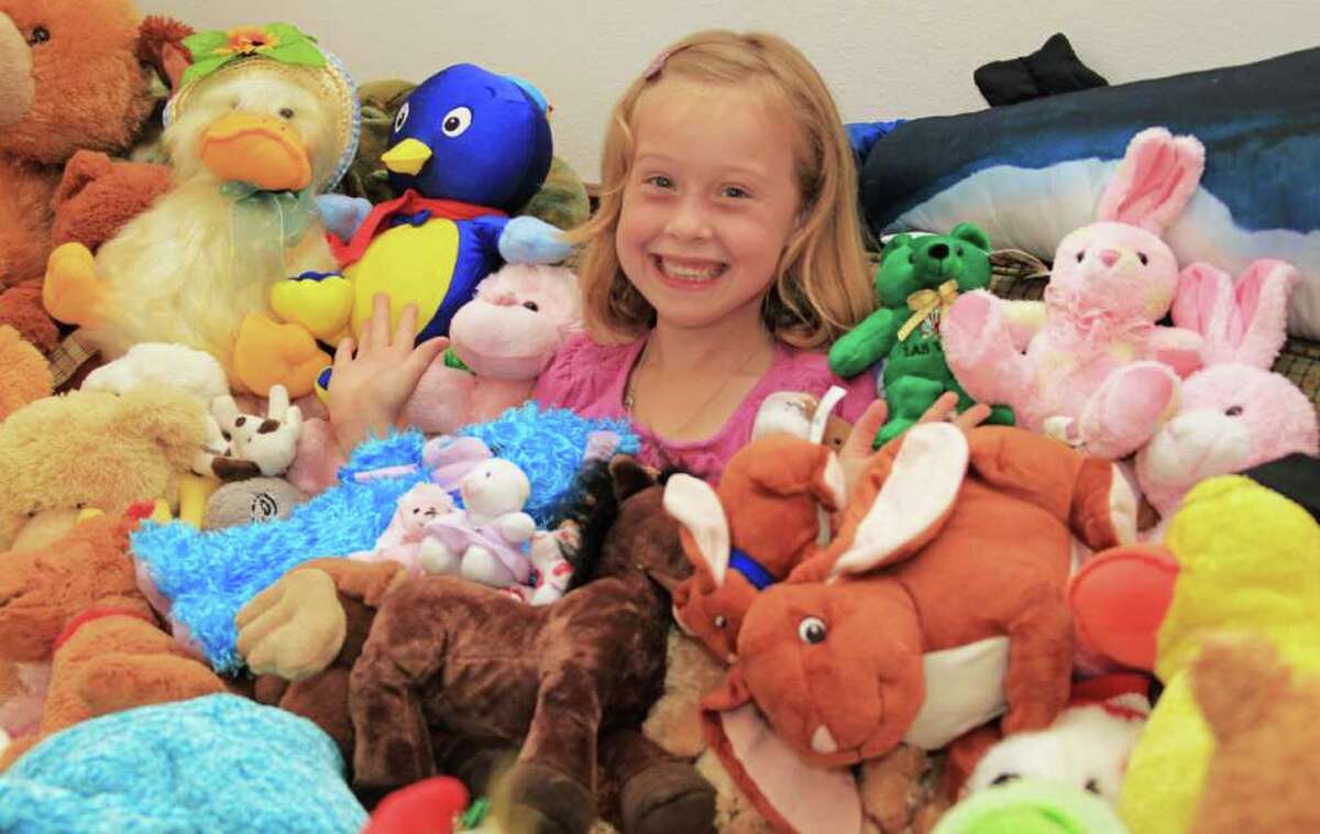 Morgan Sellers, 7, of Rosharon sits with a few of the approximately 500 stuffed animals she plans to send to Joplin, Missouri, in the next few weeks for the children impacted by the EF-5 tornado that leveled parts of the city in May. Morgan is worried children are not sleeping well at night because they do not have a stuffed animal to cuddle with when going to sleep.