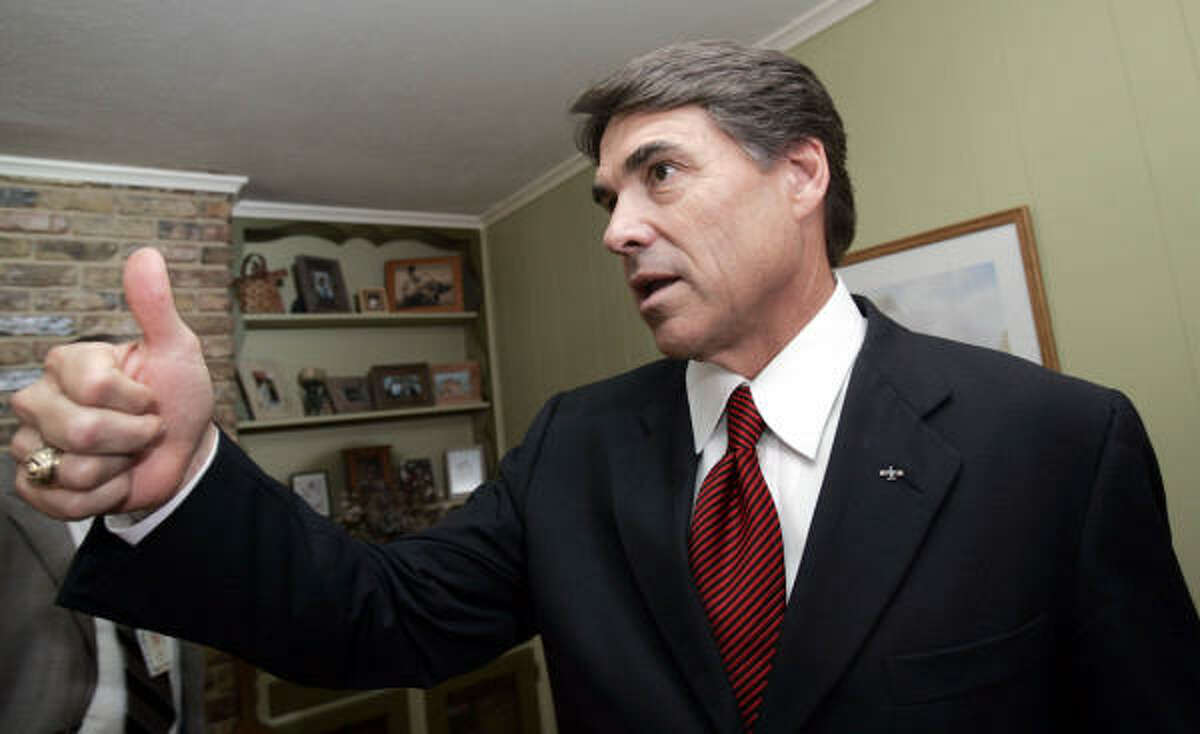 Gov. Rick Perry gives a thumbs up after a news conference at a Dallas home on Monday. State leaders looking toward the next budget face a tight money situation driven by the need to fund the new school finance package, including a cut in property tax rates.