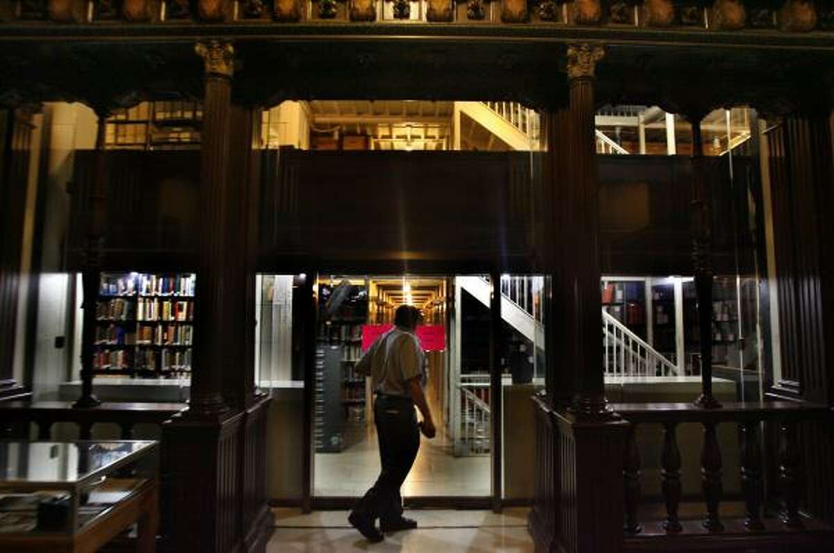 Security guard Larry Guillory walks through and checks the Houston public library's Julia Ideson building. The library is said to be haunted by a violin-playing ghost.