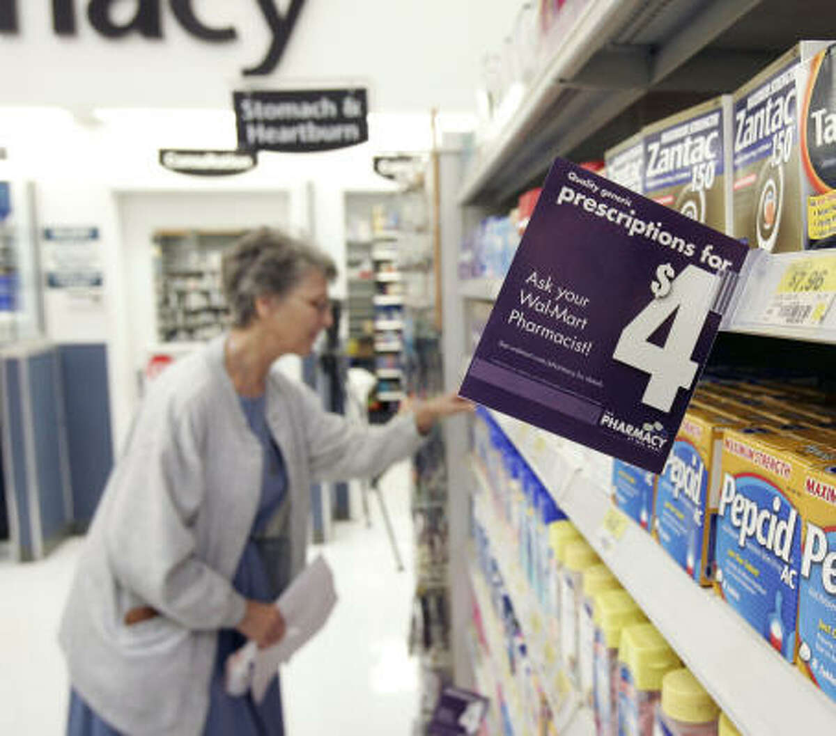 Cyrene Winkler looks through the off-the-shelf products after picking up a prescription at a Wal-Mart on Tomball Parkway. She is interested in saving money with the $4 generic drug program. After a successful test in Florida, Wal-Mart is introducing the plan in 14 additional states, including Texas.