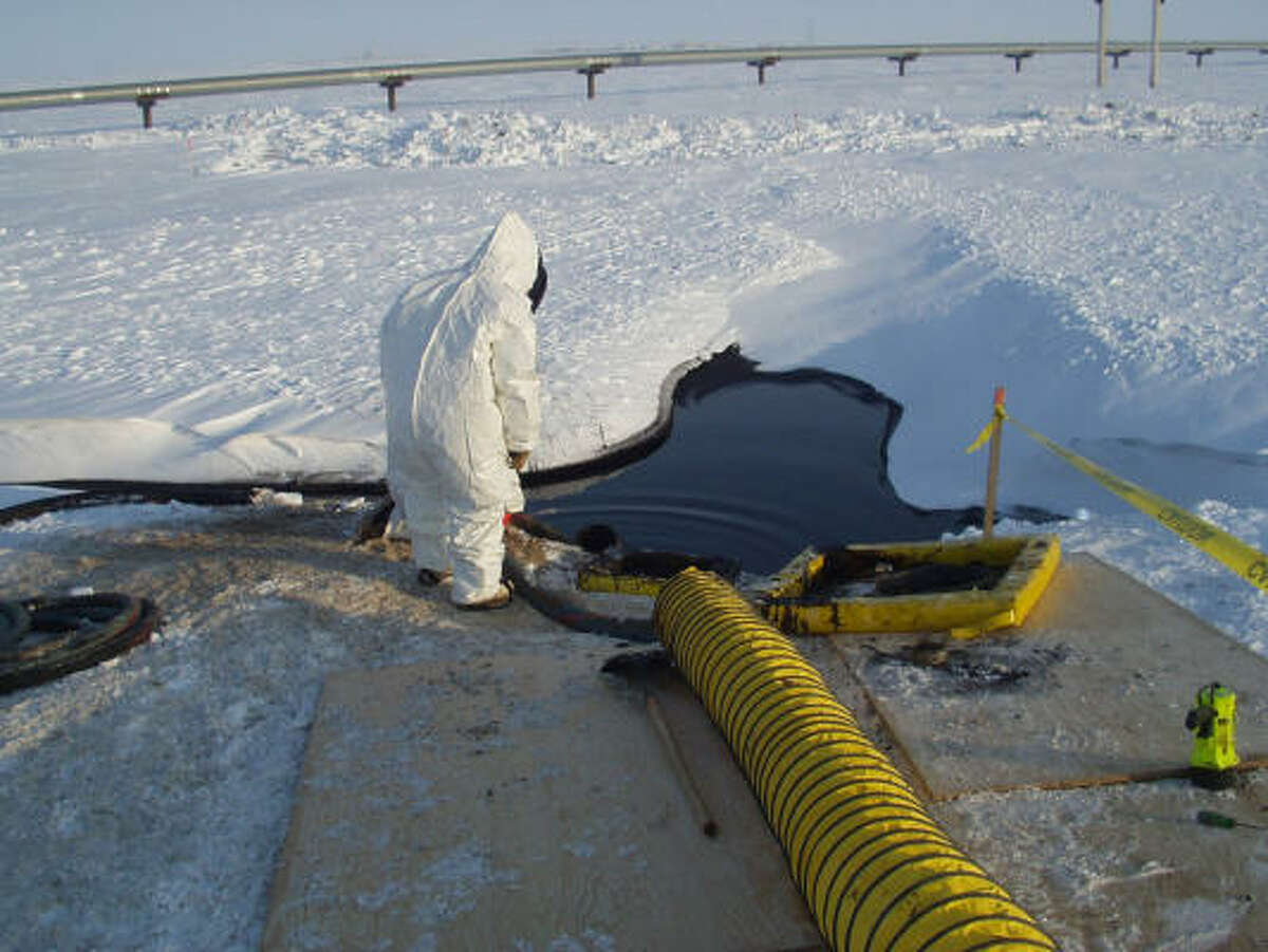 Workers help clean an oil spill caused by a leak along a 34-inch BP pipeline in March on Alaska's North Slope. An estimated 201,000 gallons of crude oil were spilled, drowning 2 acres of tundra.