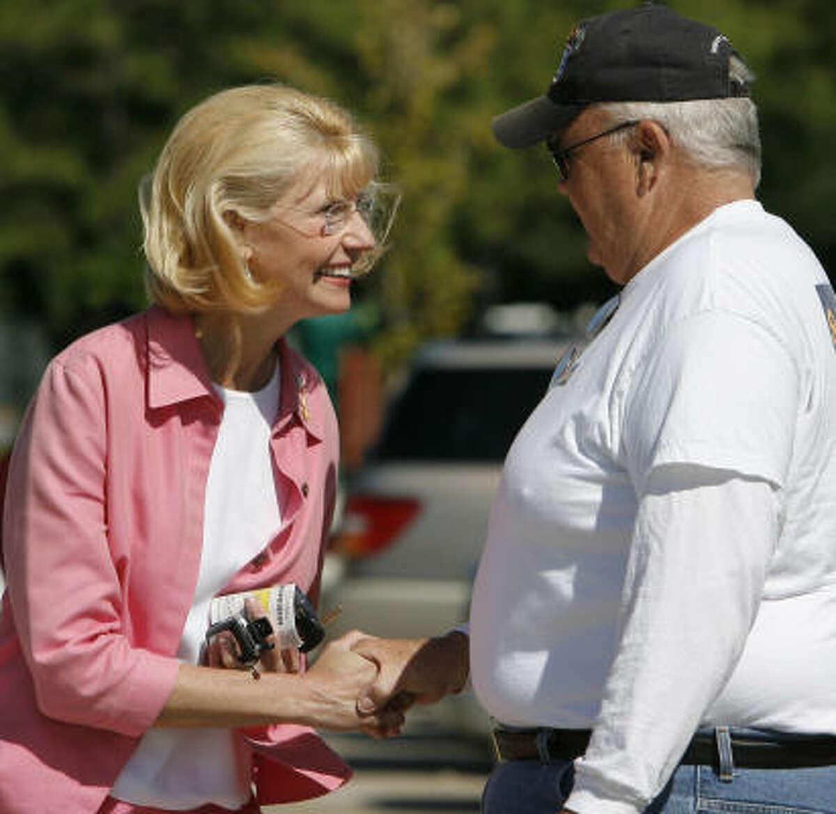 Congressional candidate Shelley Sekula Gibbs, left, talks with one of her volunteers, Bob Meaney after taking advantage of early voting at the Freeman's Branch Library in Clear Lake, Texas.