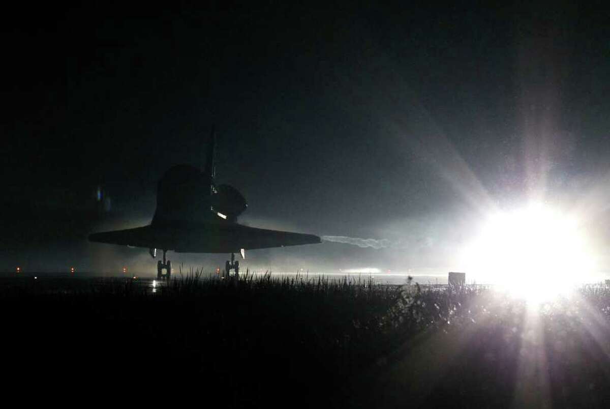 Space Shuttle Atlantis lands at the Kennedy Space Center at Cape Canaveral, Fla. Thursday, July 21, 2011. The landing of Atlantis marks the end of NASA's 30 year space shuttle program. (AP Photo/Terry Renna)