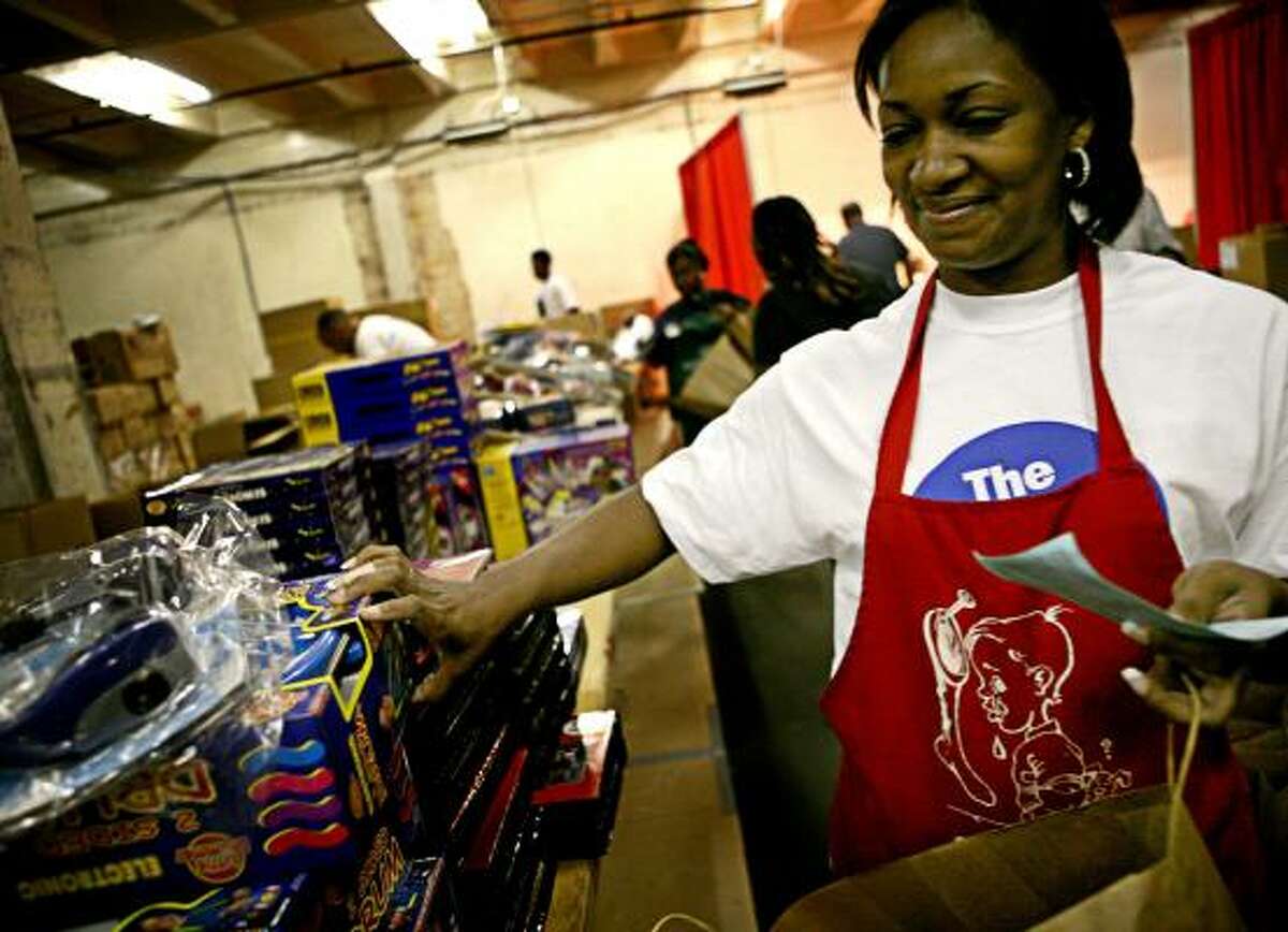 Goodfellows worker Kathy Williams distributes Christmas toys to needy families in December. Last year, donors contributed more than $1 million for Goodfellows gifts, a record for the charitable holiday program that the Houston Chronicle began on Thanksgiving 1912.