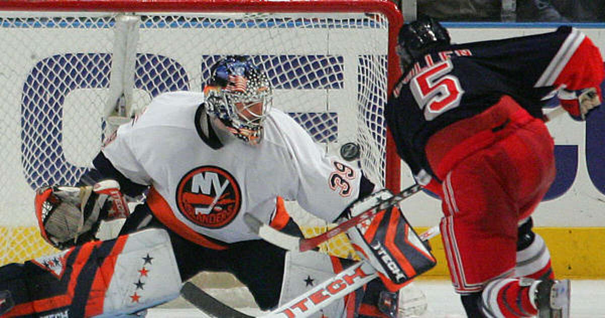 New York Rangers' Matt Cullen (5) puts the puck past Islanders goalie Rick DiPietro during a shootout The Rangers defeated the New York Islanders 2-1