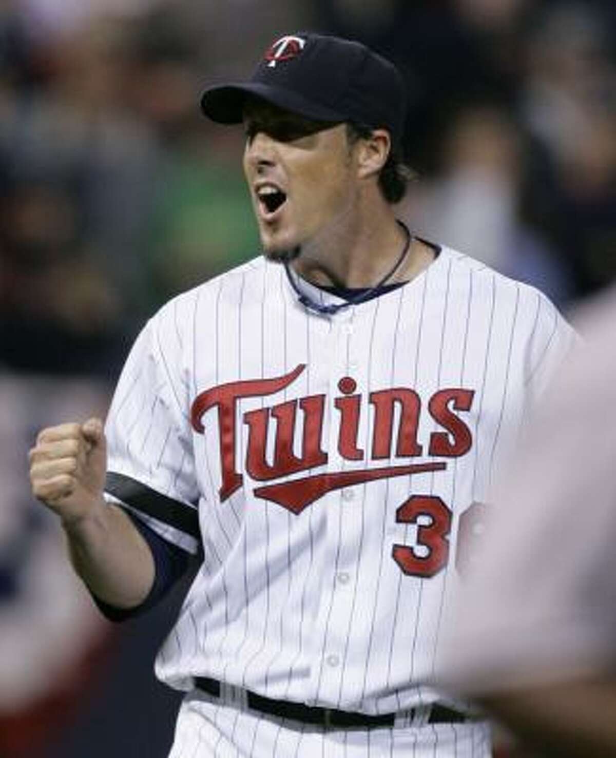 Twins closer Joe Nathan celebrates after getting Baltimore's Melvin Mora to ground out to seal Minnesota's win.