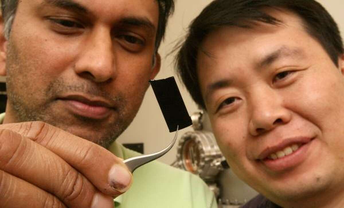 Professor Pulickel Ajayan, left, and Ligie Ci have created the darkest substance on Earth. The material could be used for collecting solar energy or improving telescopes, Ajayan said.