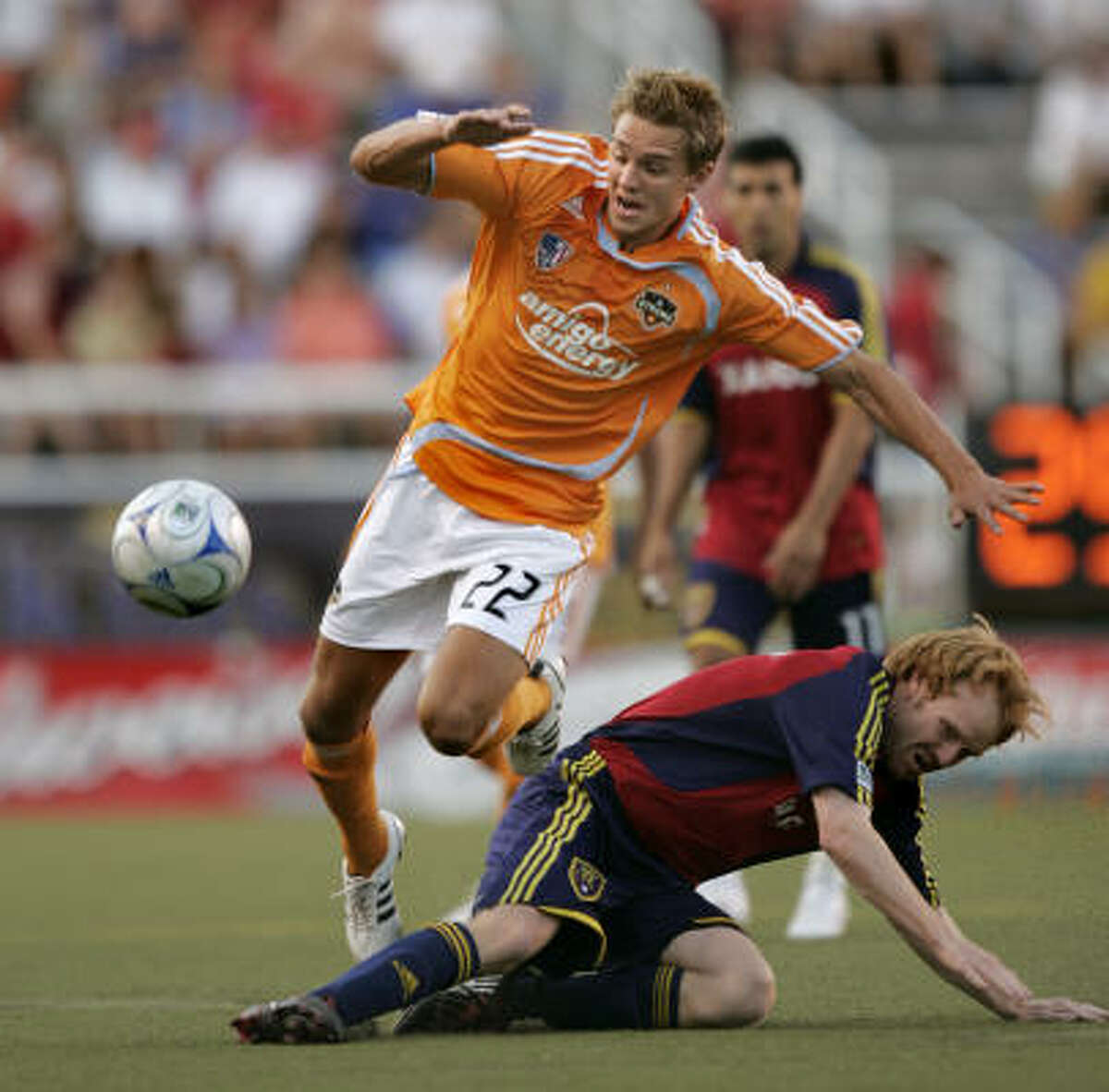 Dynamo midfielder Stuart Holden (22) passes Real Salt Lake midfielder Kenny Cutler during the first half.