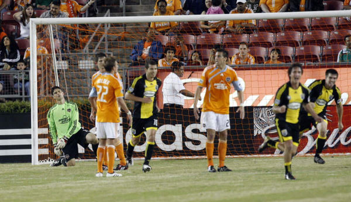 Dynamo goalkeeper Pat Onstad can only watch after the Columbus Crew tied the game 1-1 in the 82nd minute thanks to a goal by reigning league MVP Guillermo Barros Schelotto, front right.