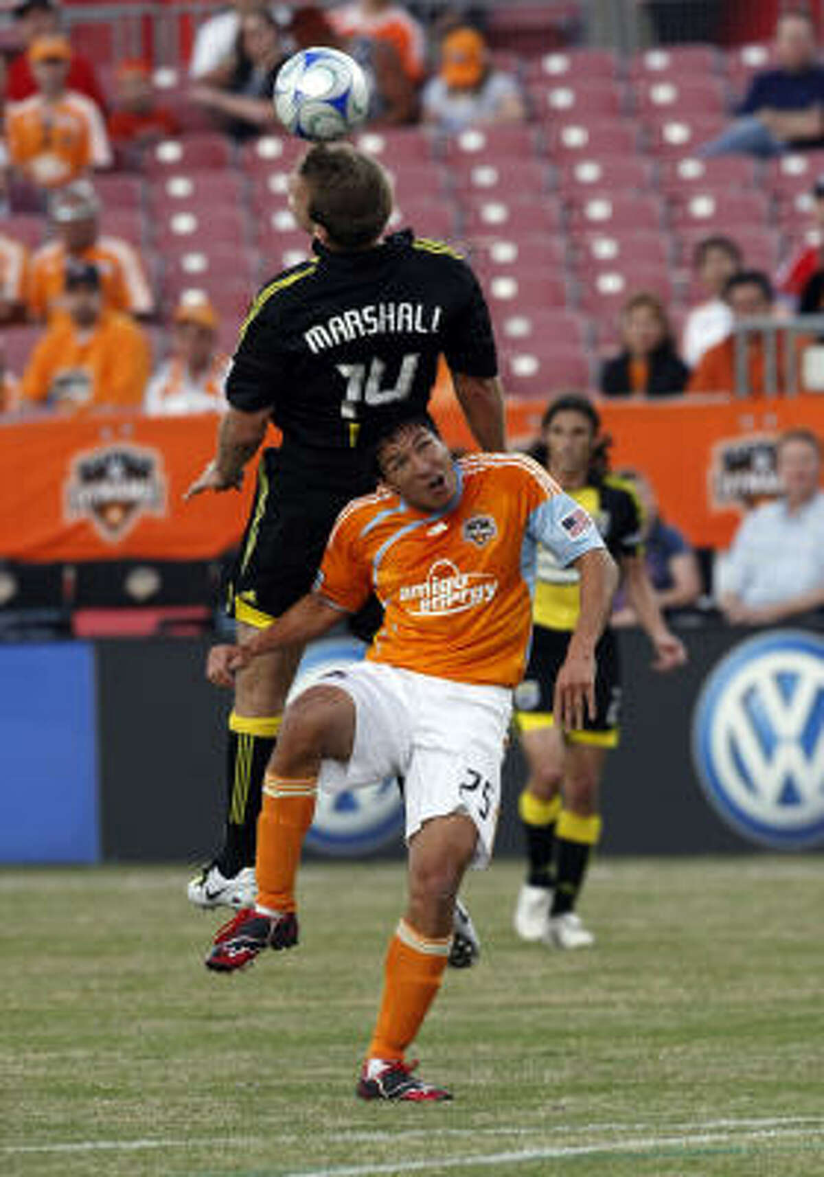 Columbus' Chad Marshall, top, heads the ball over Brian Ching in the first half.