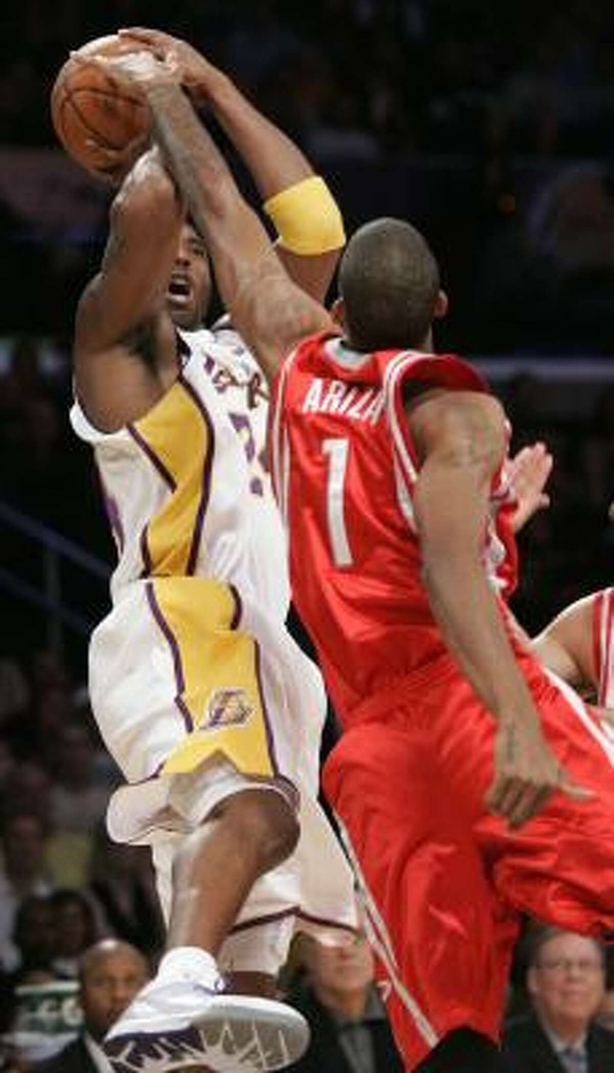 Lakers guard Kobe Bryant has his shot blocked by Trevor Ariza.