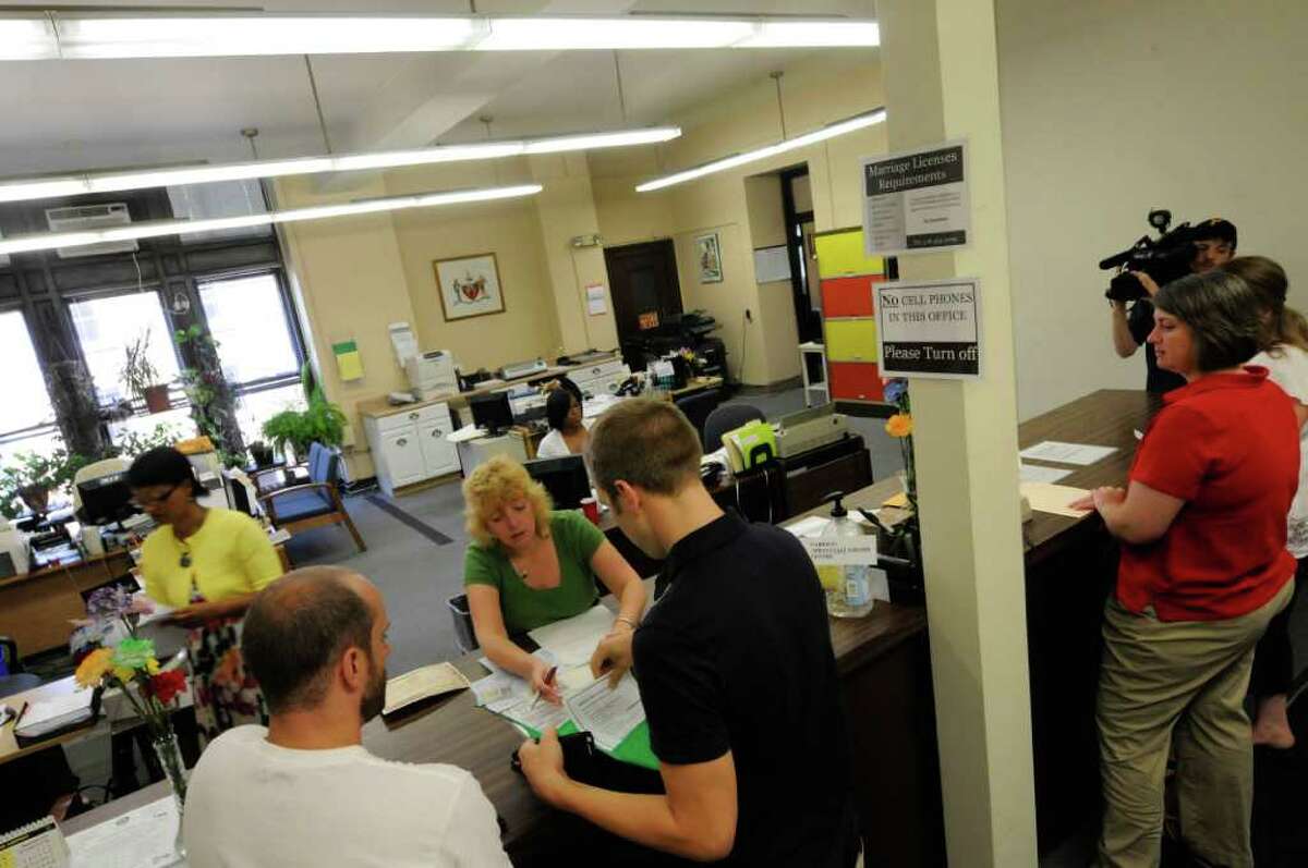 Same-sex couples planing to marry Brian Banks and Jon Zehnder,left, and Joanne Trinkle and Beth Relyea drop of their applications at the Albany City Clerks office in Albany, NY Friday July 22,2011.( Michael P. Farrell/Times Union)