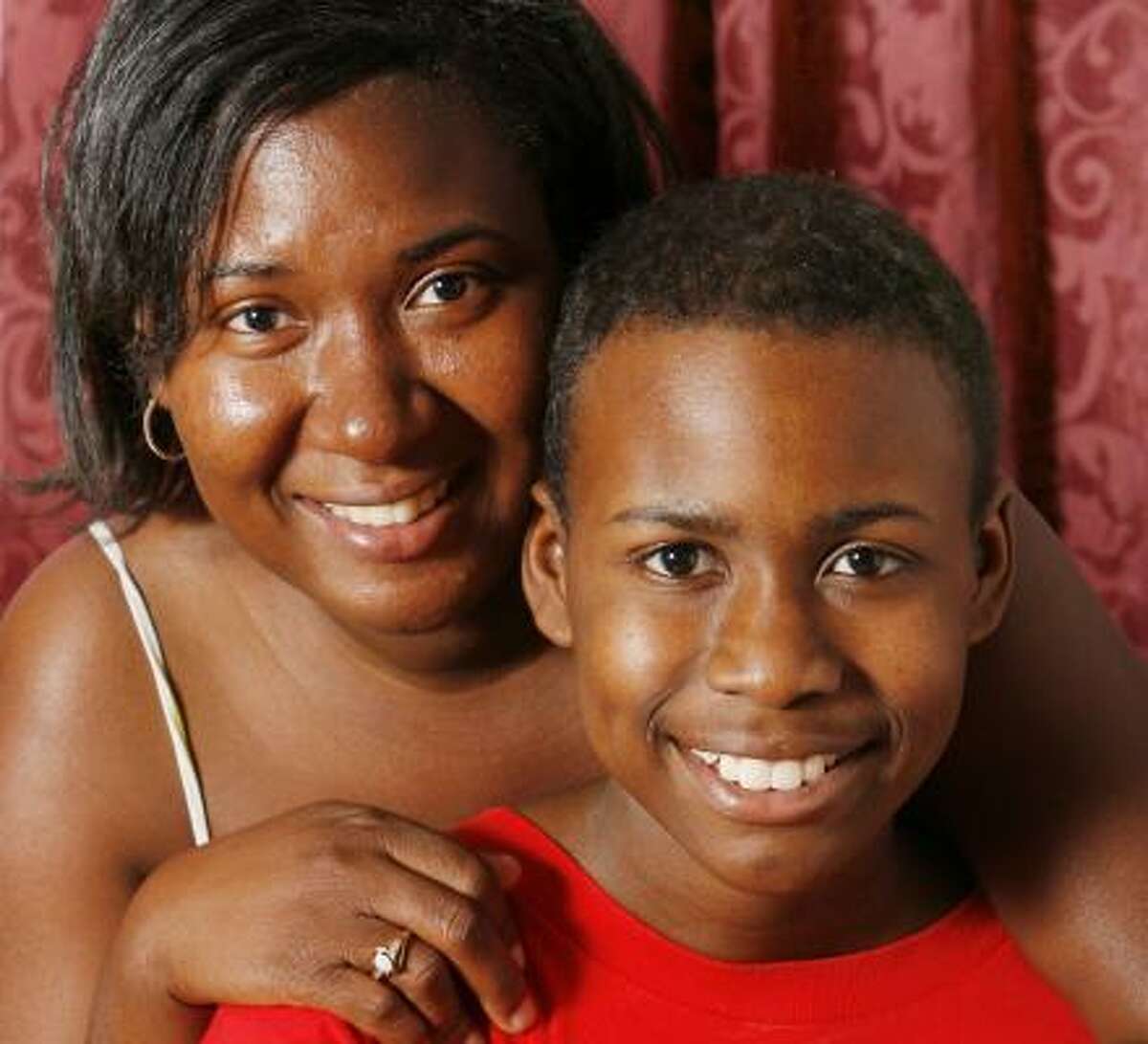 Tamika Scott is shown in 2006 with her son, Devante Johnson, 13, who lost health coverage for four months after a Medicaid paperwork error.