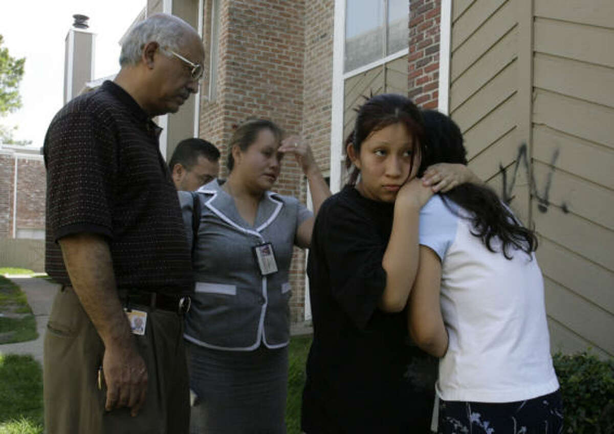 Ariadna Vazquez, 18, second from right, comforts her mother, Elvira Vazquez, as family members of David Vazquez, 10, mourned his death on Thursday, July 17.
