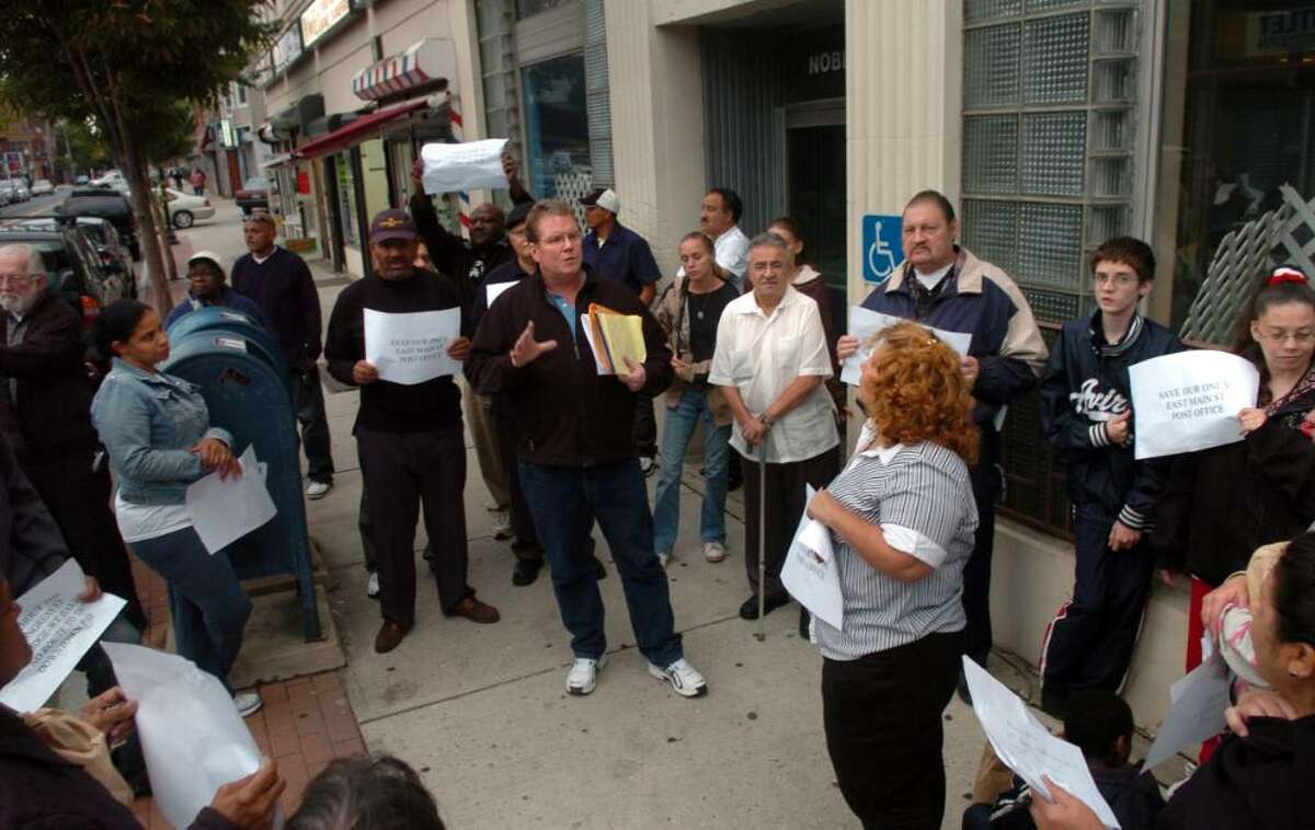 Michael Dennehy, president of the Bridgeport chapter of the American Postal Workers Union, talks to supporters of the Noble Postal Station Tuesday Sept. 29, 2009 outside the Bridgeport, Conn. office which is on a list to be closed later this year.