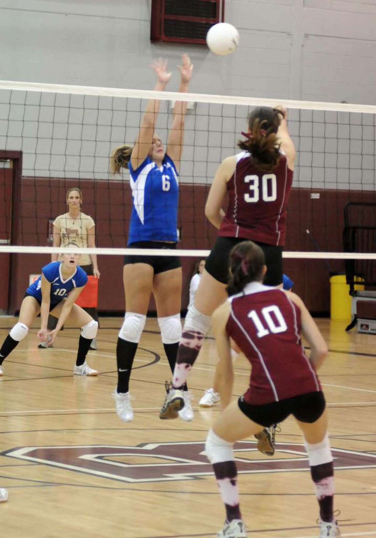 Brookfield's #6, Kathryn Marron reaches to block the ball after Bethel's #30, Madison Ferraro hits it over the net. Brookfield High School vs Bethel High School girls Volley Ball. Tuesday Sept. 29, 2009.
