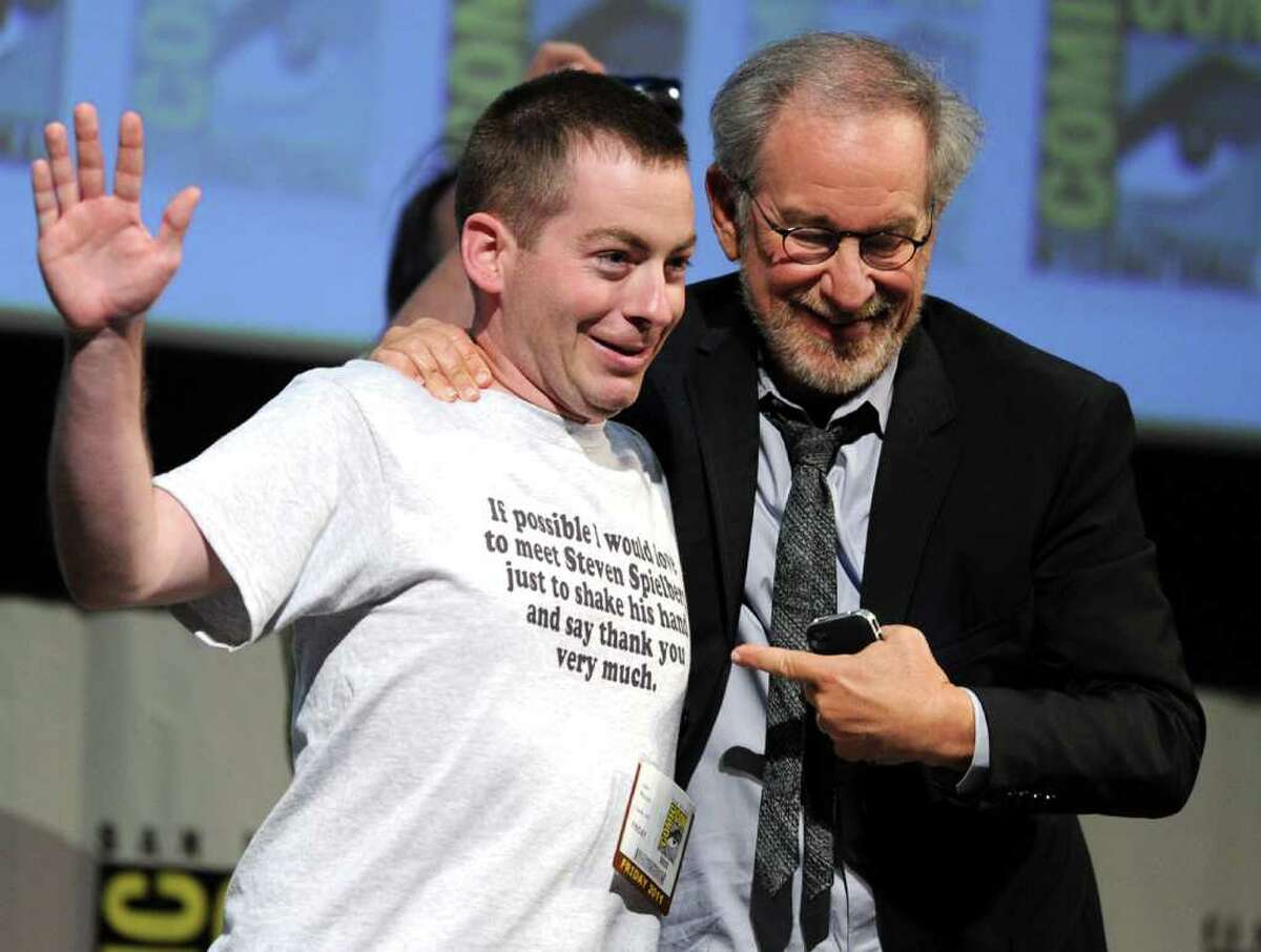 Director/producer Steven Spielberg (right) poses with fan John Mazzoni at "The Adventures Of Tintin" Panel during Comic-Con 2011 on July 22, 2011 in San Diego, California.
