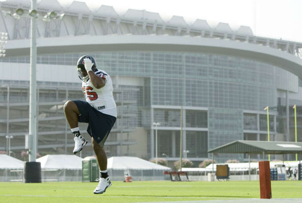 July 25: Texans first-round pick Duane Brown warms up after signing his contract just in time to join the team for their morning workout. The rookie offensive tackle, however, was an hour late to practice.