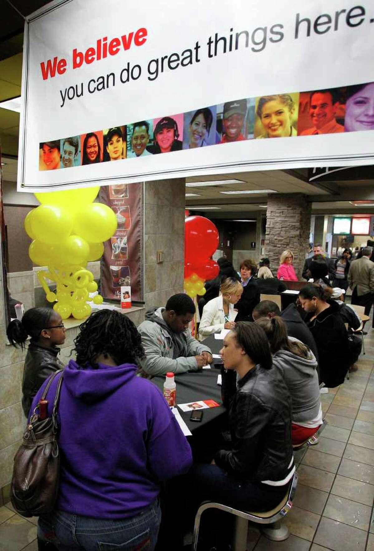 FILE - In this April 19, 2011 file photo, McDonald's National Hiring Day job seekers fill out applications before being interviewed during the lunch hour at a downtown Pittsburgh McDonald's restaurant. Strong second-quarter earnings from McDonalds and Caterpillar Friday, July 22, 2011, are just the latest example of a boom in corporate profits. But job growth is stagnant and unemployment is rising.(AP Photo/Gene J. Puskar, file)