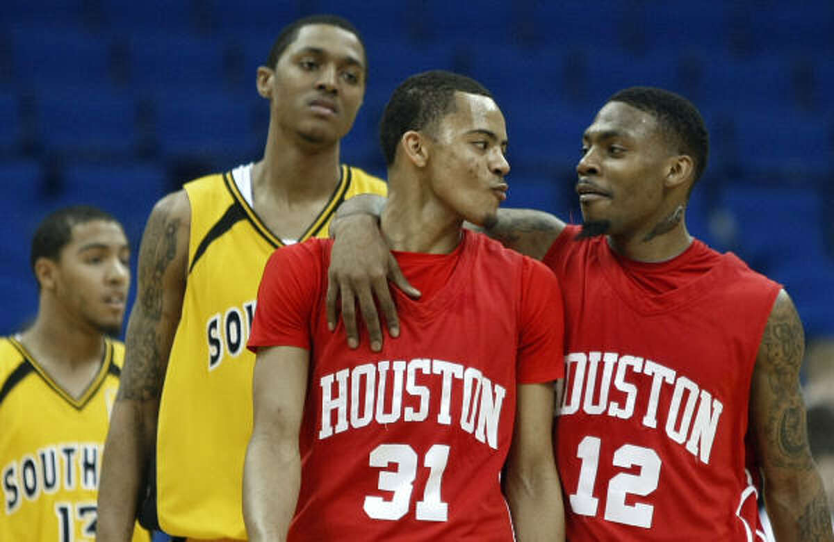 Houston's Adam Brown (31) and Aubrey Coleman (12) celebrate their 74-66 victory over Southern Miss.
