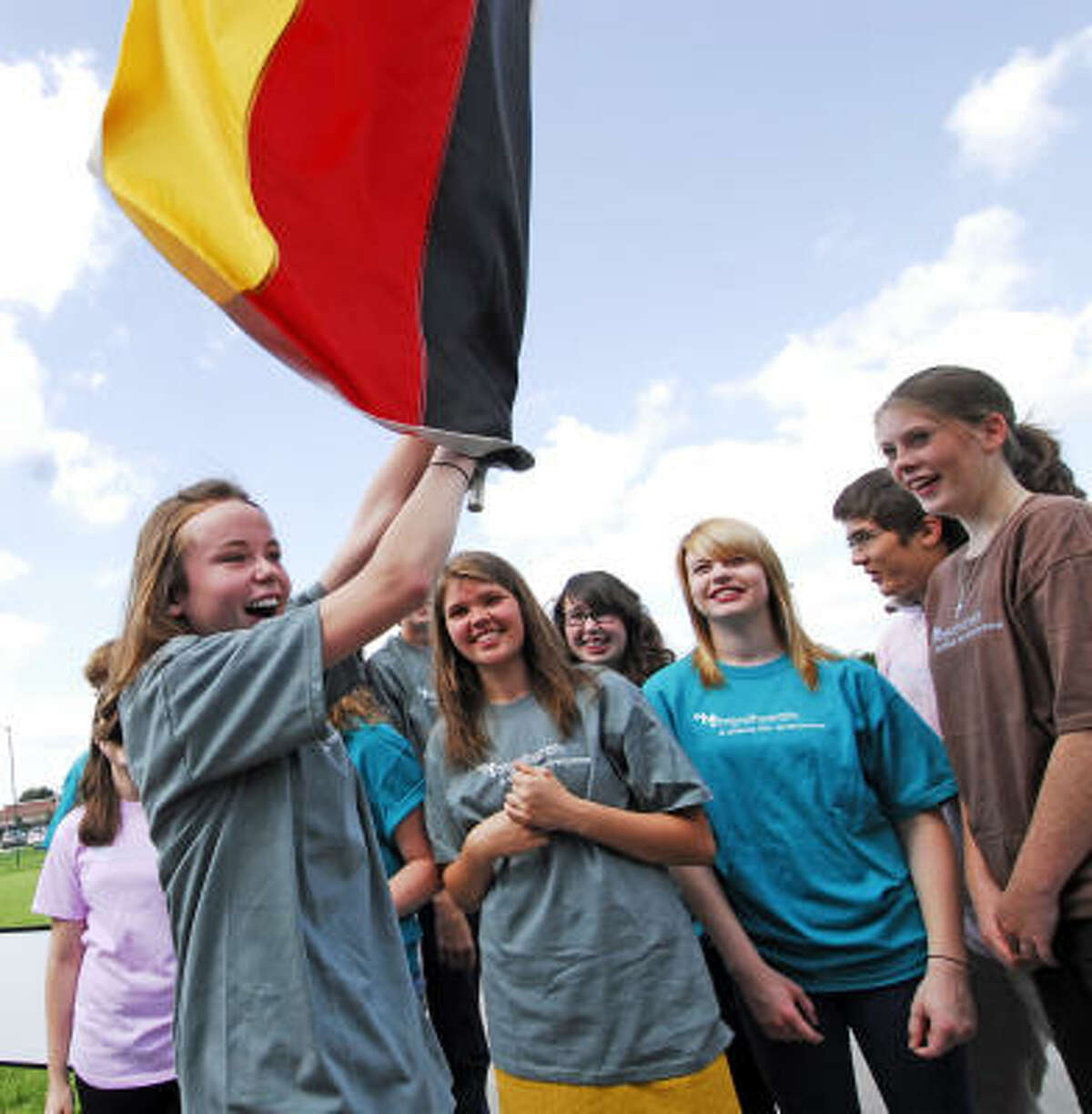 Fifteen year old Katherine Dumanoir (cq) (at left) (77450) carries the German flag for a group photo of high school students from Living Word Lutheran Church in Katy who are traveling to Germany to learn more about Martin Luther. Going on the trip with her are fifteen year old Darby Dillard (cq) (shoulder length brown hair) (77450), sixteen year old Katy Aus (cq) (glasses and curly black hair) (77494), fifteen year old Lauren Simmons (cq) (blonde hair) (77094), seventeen year old Richard Reid (cq) (glasses) (77494), and seventeen year old Jennifer Spain (cq) (brown shirt hair in ponytail) (77450).