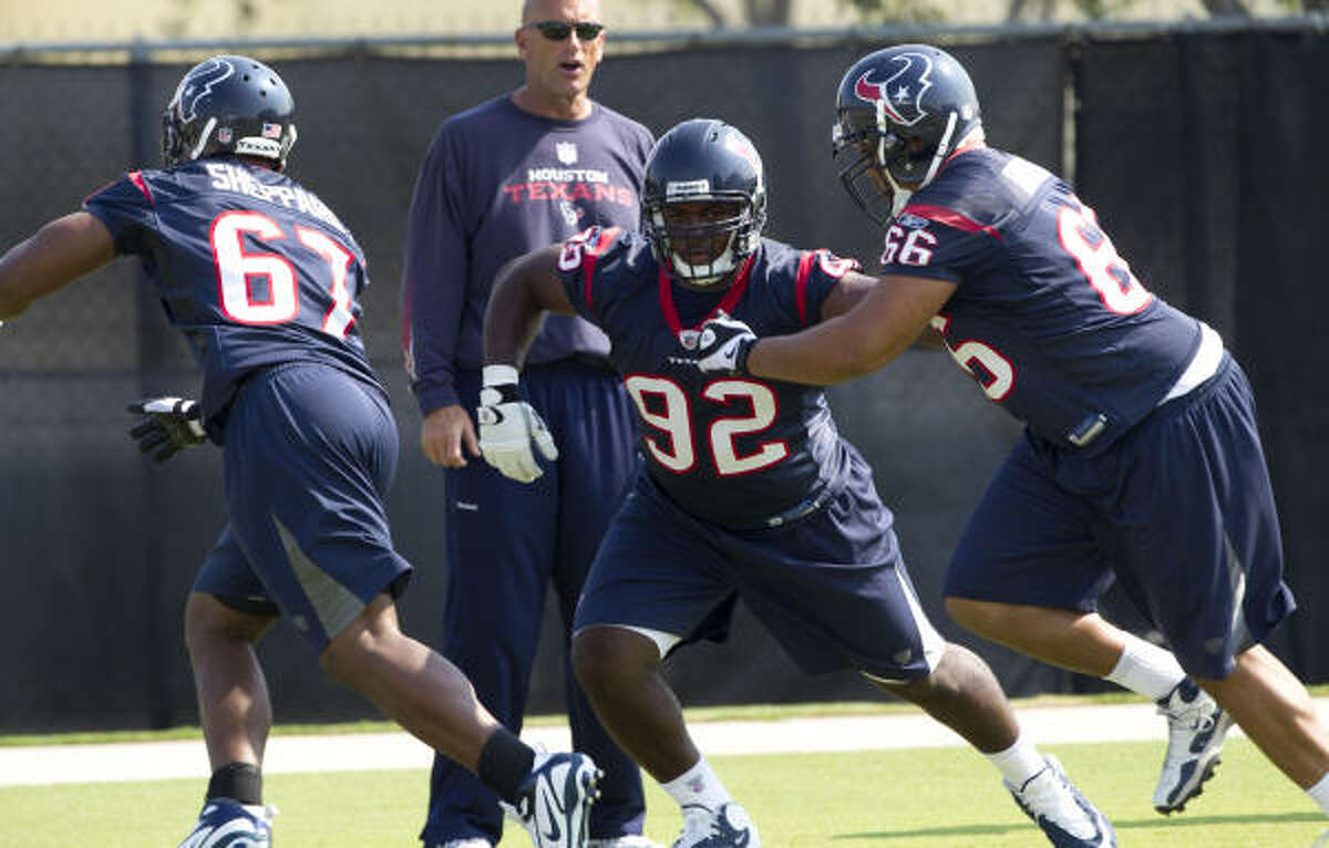 Texans defensive tackle Earl Mitchell, center, is competing for playing time behind Amobi Okoye and Shaun Cody.