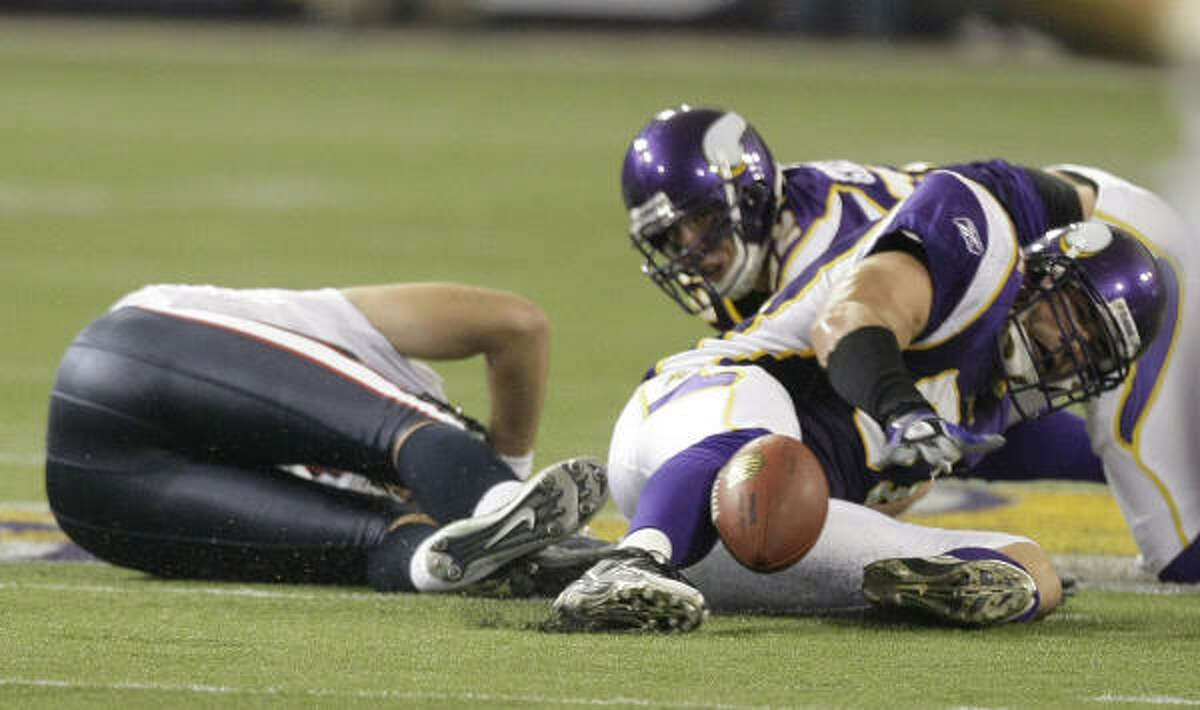 Vikings linebacker Ben Leber (right) reaches out to recover a fumble by Texans quarterback Matt Schaub (left), who was sacked during the second quarter.