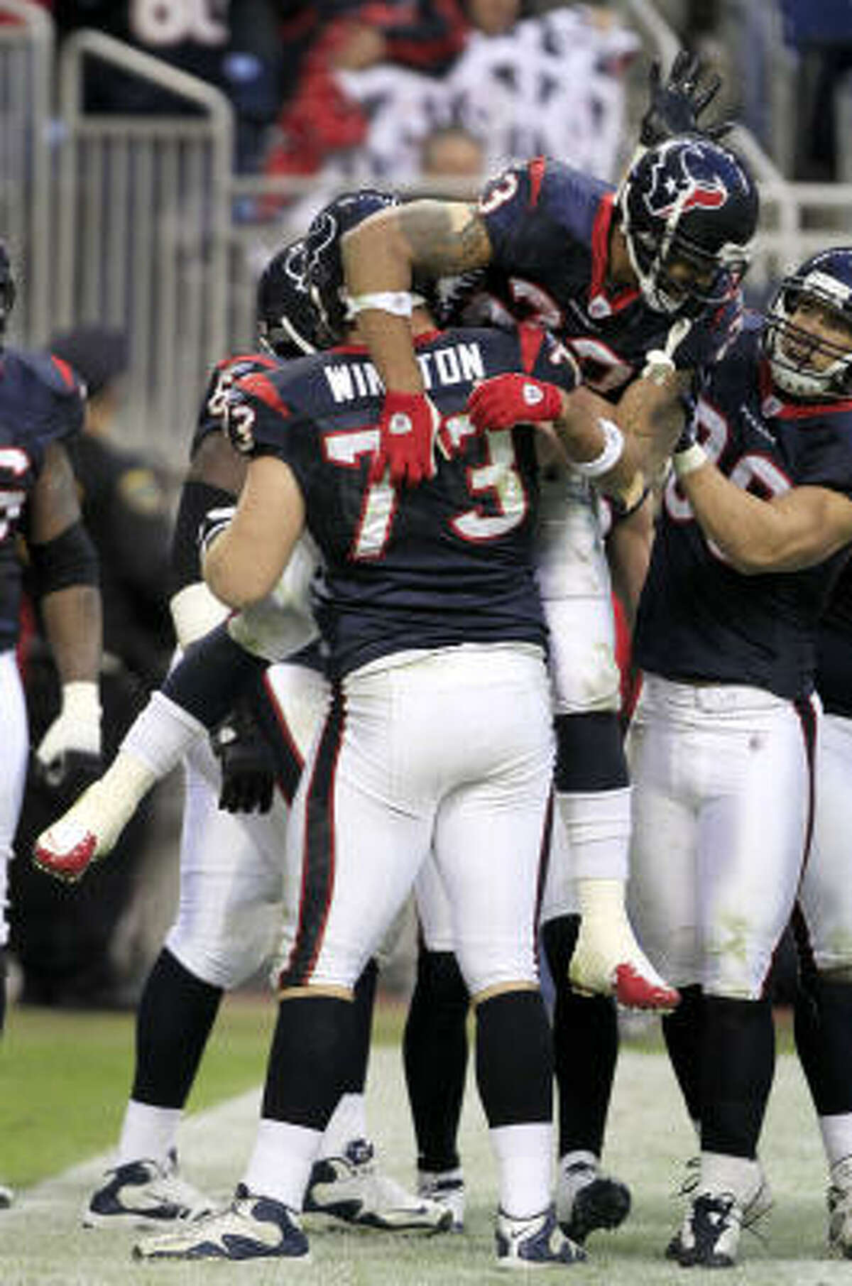 Texans running back Arian Foster is lifted in the air by offensive tackle Eric Winston (73) after Foster scored on a 35-yard touchdown run in the fourth quarter. Foster rushed for 180 yards on 31 carries in the victory.