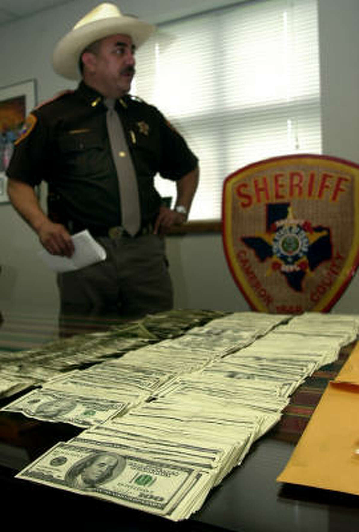 Before: In June 2003, Cameron County Sheriff Conrado Cantu holds a news conference to announce the seizure of more than $40,000 during the search of a bus outside a Brownsville convenience store.