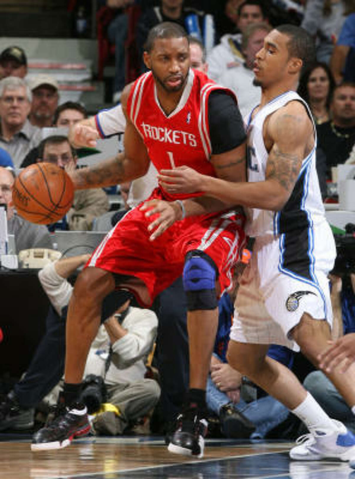 Tracy McGrady posts up Magic guard Courtney Lee in the second quarter.